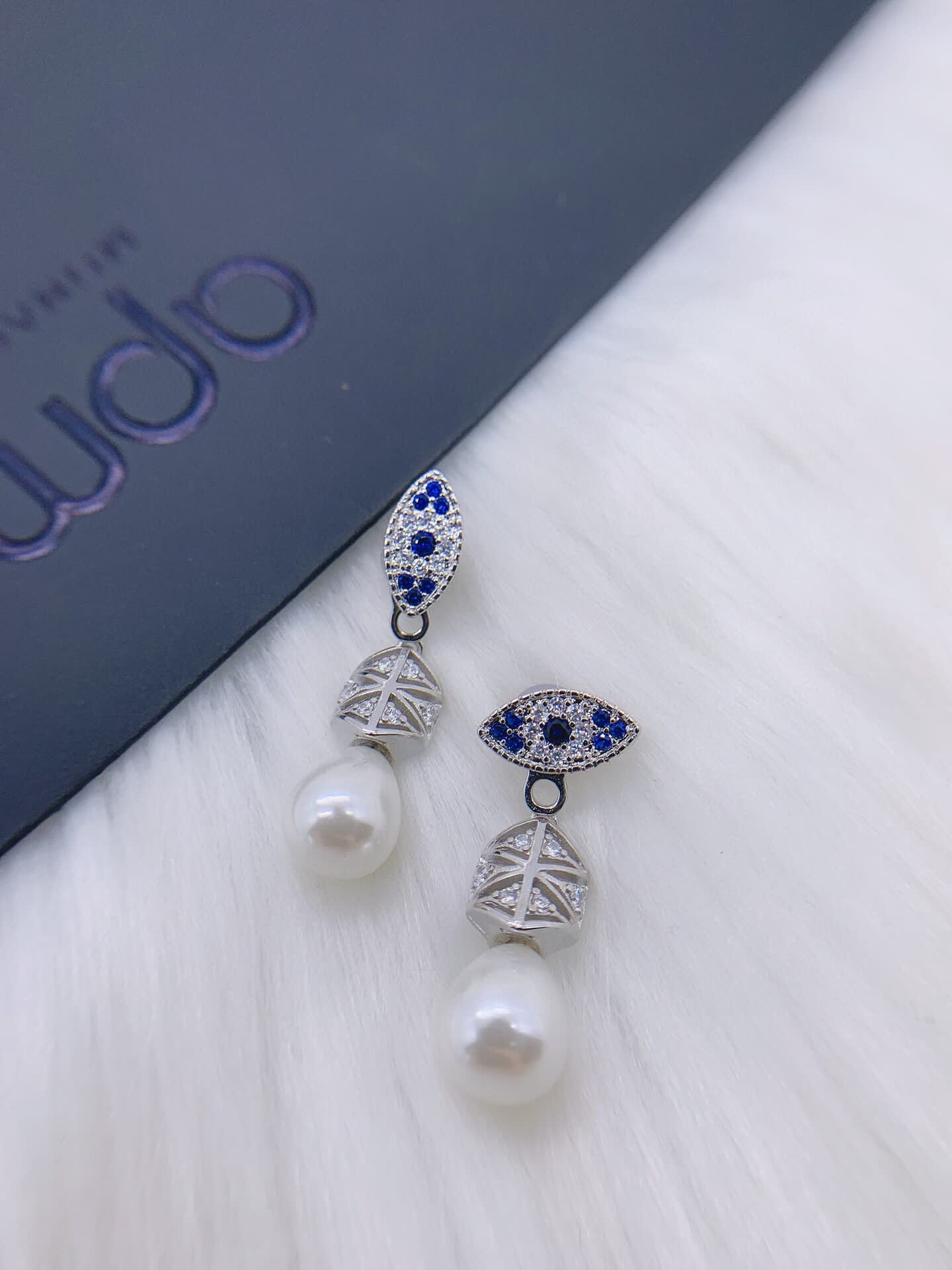 APM Monaco Elegant Pearl and Sapphire Eye Stud Earrings